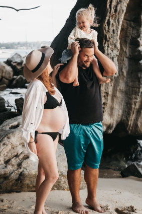 Stay-at-home dad Peter Tos with his daughter Mahli and then expecting wife Rebecca. 