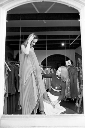 Dressing a model at her first boutique, in Sydney’s Surry Hills, in 1975. 