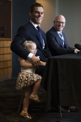 Family club: Halle  Morris crashes dad John's press conference while Sharks CEO Barry Russell looks on.