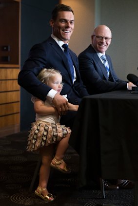 Family club: Halle  Morris crashes dad John's press conference while Sharks CEO Barry Russell looks on.