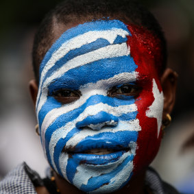 A student's face painted with the separatist Morning Star flag. 