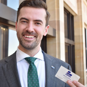 New opposition leader Zak Kirkup with the same type of business card he once handed to Prime Minister John Howard.