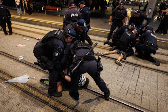 Police restrain protesters on Monday.