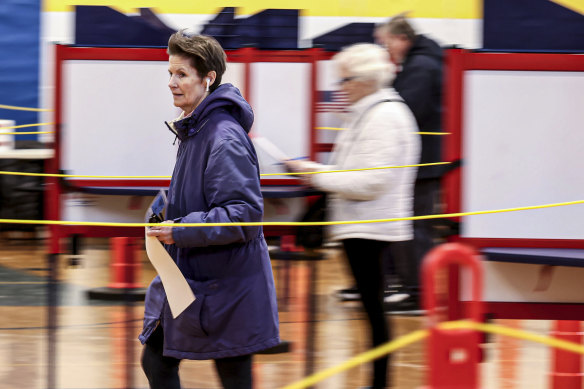 A woman makers her way to cast her ballot at a polling place in Foxborough, Massachusetts.