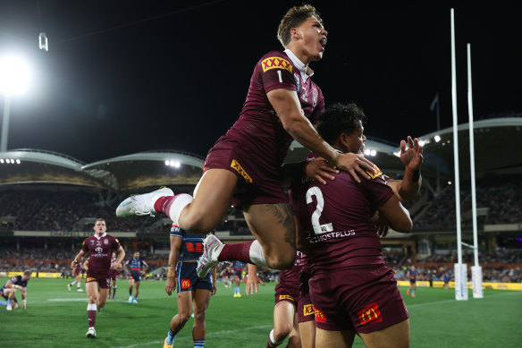 Selwyn Cobbo celebrates with Reece Walsh after scoring for the Maroons.