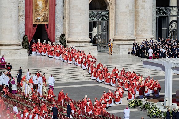 Cardinals lining the way between St Peter’s Basilica and the altar. They will decide the next pope in the conclave.