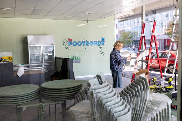 Western Bulldogs player and artist, Cody Weightman, painting a mural at the new Salvos’ café. The Bulldogs are supporting the project. 