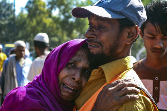 'They are taking us forcefully': a Rohingya man comforts a refugee woman as they are relocated to Bhashan Char. 