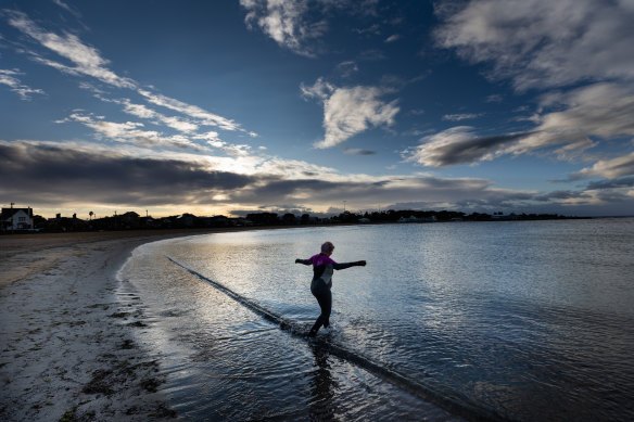 Anne Young, 70, ignores the frigid weather for an invigorating dip at Williamstown.