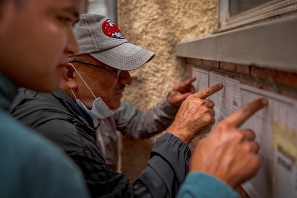 Visitors scan the pictures and lists of the missing.