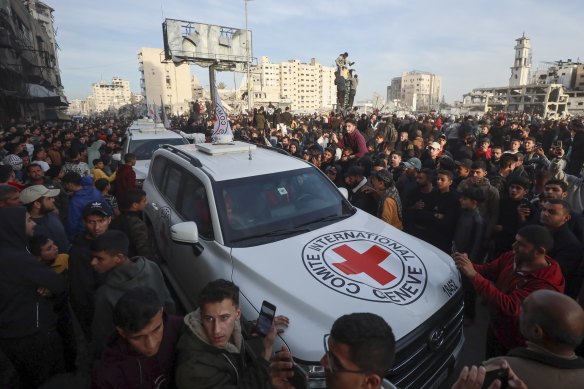 A Red Cross convoy arrives to collect Israeli hostages released after the ceasefire agreement between Israel and Hamas took effect.