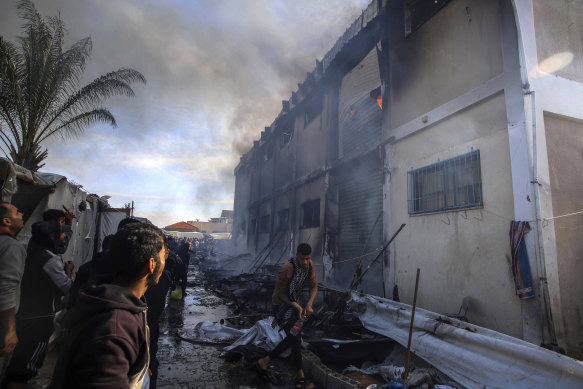 Palestinians try to extinguish a fire at a building of an UNRWA vocational training centre earlier this week.