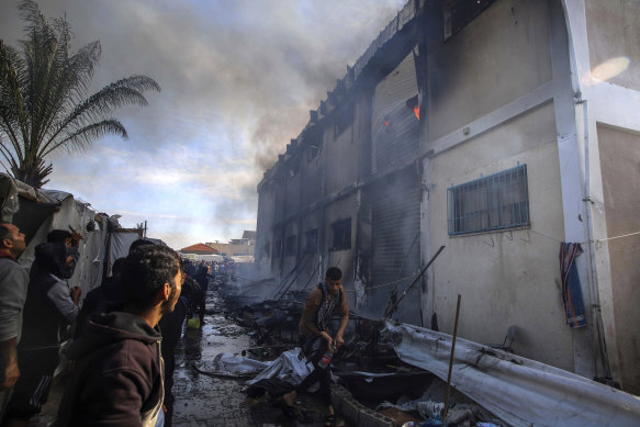 Palestinians try to extinguish a fire at a building of an UNRWA vocational training centre earlier this week.  