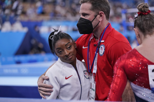 USA coach Laurent Landi embraces Simone Biles after she quit the Team final at the Tokyo Olympics.
