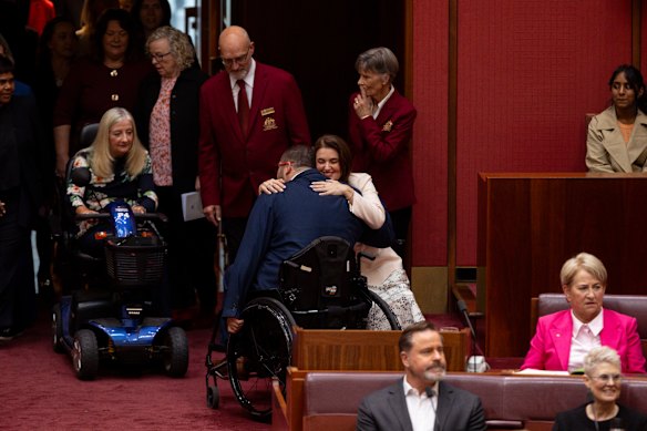 Member for Dickson Ali France greets Senator Jordon Steele-John with an embrace during the opening of the 48th parliament.