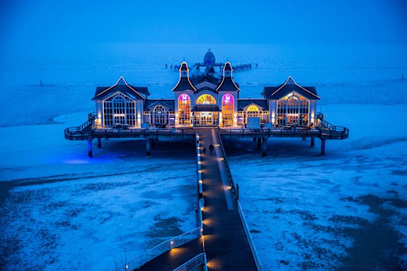 The pier on the Baltic coast on the island of Ruegen, illuminated in the evening, in Sellin, Germany.