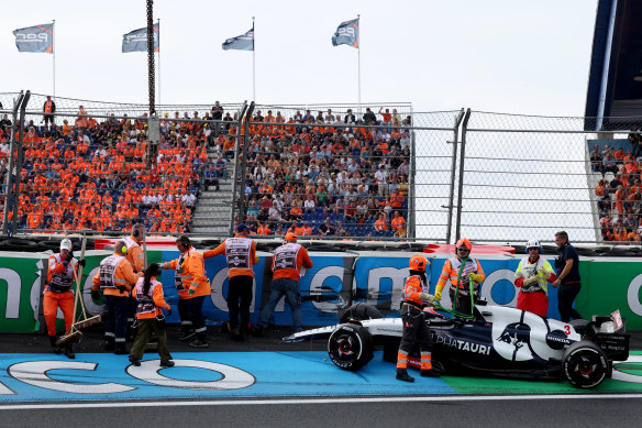 Daniel Ricciardo’s AlphaTauri is removed from the track after the crash in the practice session at the Dutch Grand Prix.