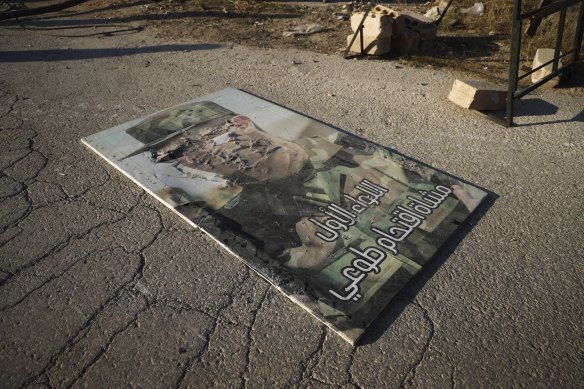 A defaced portrait of Syrian President Bashar Assad lies on the ground in the town of Maarat al-Numan.