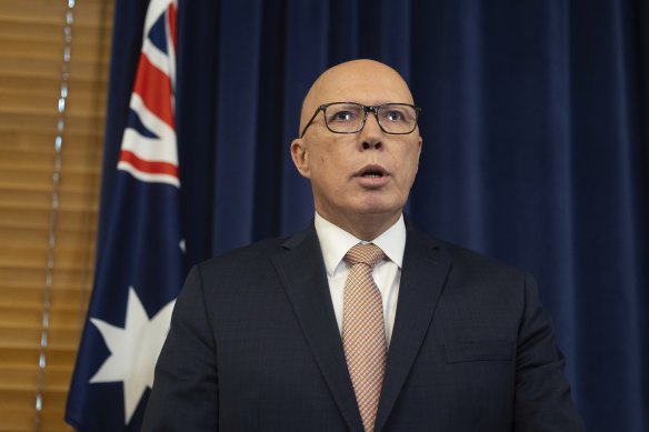 Opposition Leader Peter Dutton during a press conference in July, flanked by the Australian flag.
