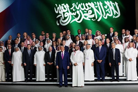 Woodside boss Meg O’Neill is the only Australian presence as US President Donald Trump and Saudi Crown Prince Mohammed bin Salman pose for a photo with business leaders attending a Saudi-US business investment forum in May. 