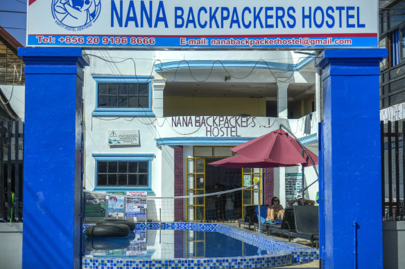 A foreign tourist couple rest near a swimming pool at Nana Backpackers Hostel in Vang Vieng, Laos.