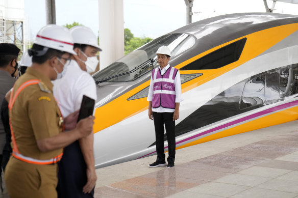 Widodo stands in front of the new, Chinese-built Jakarta-Bandung high speed railway earlier this month.