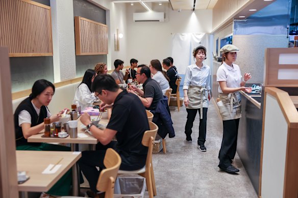 The ramen shop is small, bright and pumping with Japanese hyper-pop.
