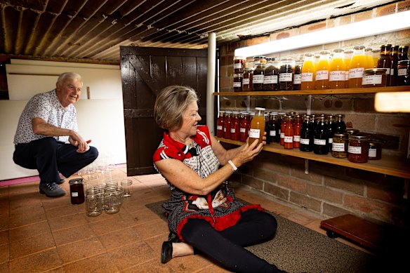 Mick and Maris Cummins with some of her produce, including (top shelf, right) bottles of her “adult” cordial called
“No Going Back!”