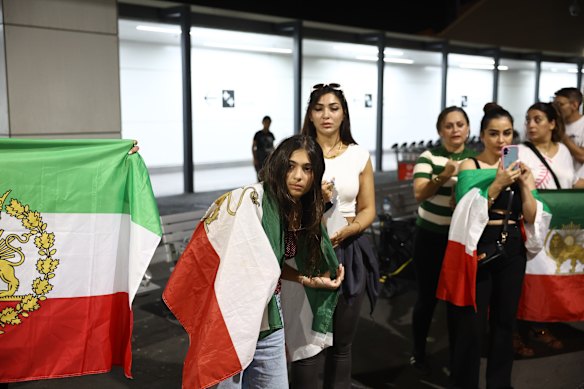 Iranian-Australians wait at the airport, hoping to have the women’s soccer team remain in Australia. 