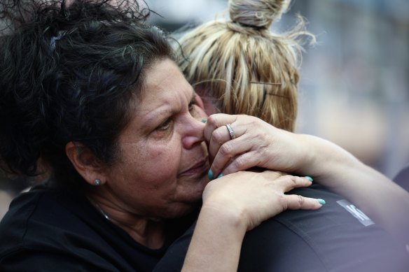 Mechelle Turvey, mother of Cassius Turvey, embraces Emily Farmer during a rally for her son