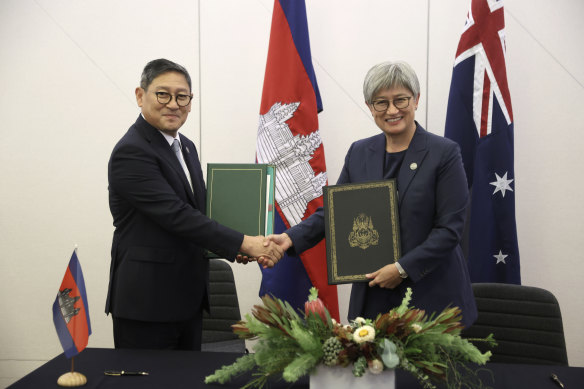 Cambodian Foreign Minister Sok Chenda Sophea shakes hands with Australian Foreign Minister Penny Wong following a meeting at the ASEAN-Australia Special Summit.