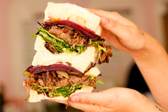 The Beefed Up with slow-cooked beef, cheddar, pickles, greens, truffle mayo and salsa verde.