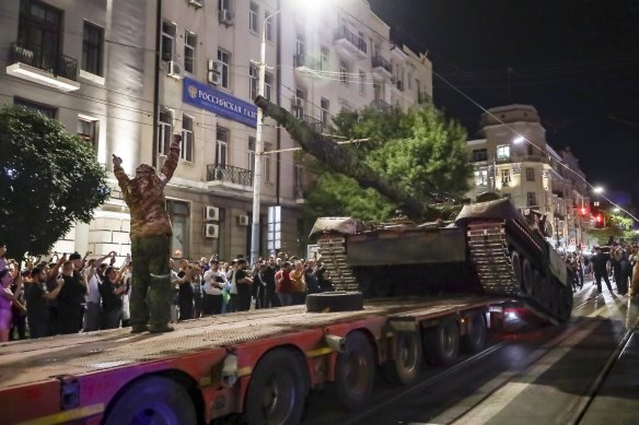 Members of the Wagner Group military company load their tank onto a truck on a street in Rostov-on-Don during last weekend’s attempted coup.