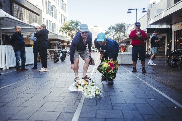 People lay flowers at the scene in Bondi Junction on Sunday morning.