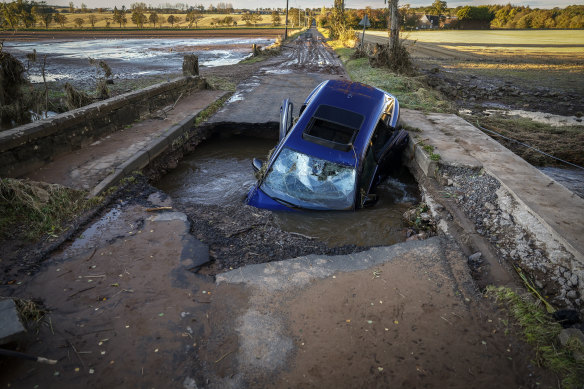 A car is seen in on bridge washed away following yesterday’s torrential rain in Dundee, Scotland. 