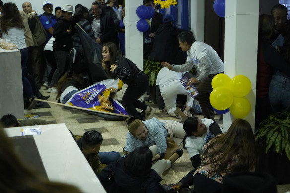 Supporters of presidential candidate Fernando Villavicencio run for cover after he was shot to death while at a campaign rally outside a school in Quito, Ecuador.