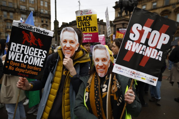 People wearing Gary Lineker masks march during a Stand Up To Racism protest at George Square on March 18, 2023 in Glasgow, Scotland. 