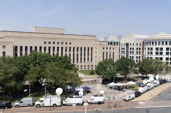 Television news crews set up outside federal court in Washington.