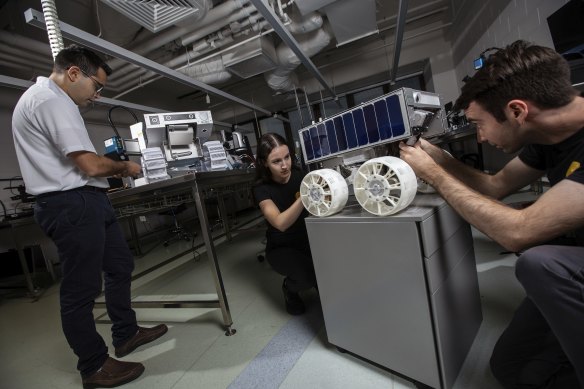 Lunar Outpost Oceania engineers work with their lunar rovers team at RMIT University.