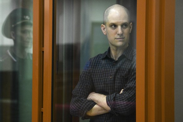 Wall Street Journal reporter Evan Gershkovich stands in a glass defendant’s booth in a Russian courtroom in June.