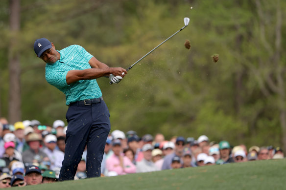 Tiger Woods plays his shot from the 12th tee, and made the cut at the Masters.