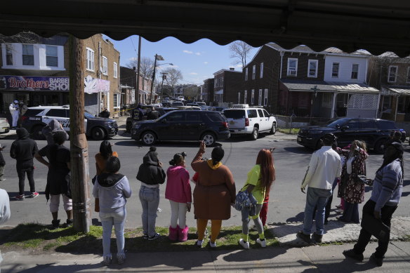 Neighbours look on as police continue to negotiate.
