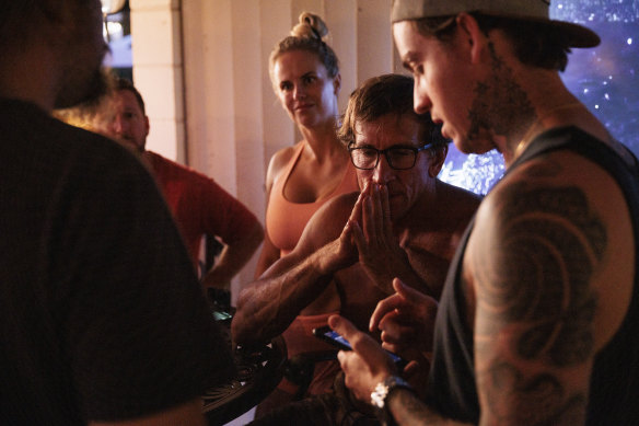 Paul Romero listens as Amory Mowrey, right, gives an update after spending the day bringing supplies to people affected by wildfires in West Maui in Kihei, Hawaii.