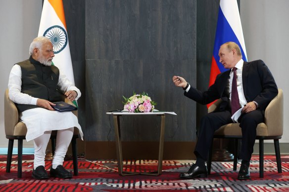 Russian President Vladimir Putin, right, speaks to Indian Prime Minister Narendra Modi.