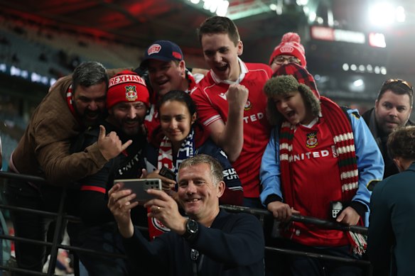 Wrexham AFC manager Phil Parkinson takes a selfie with fans ahead of the match with Melbourne Victory at Marvel Stadium.