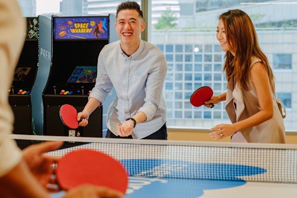 Employees in the Singapore office of Salesforce take a break for a game of ping pong.