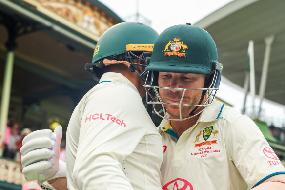 David Warner and Usman Khawaja head out to bat at the end of day one.