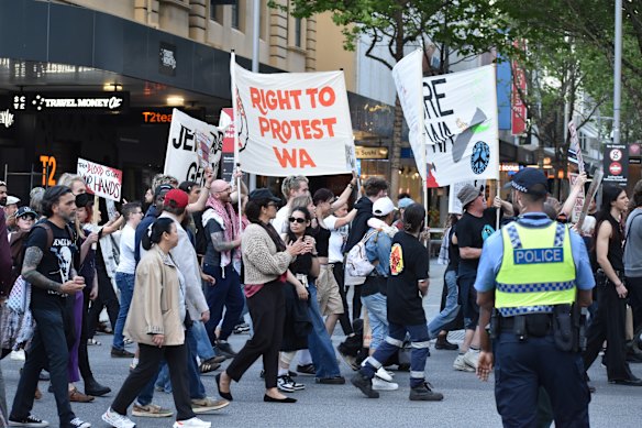 Protesters march through Perth’s CBD on Tuesday evening to rally against the Land Forces defence expo.