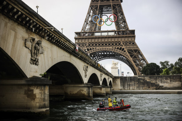 A rescue boat cruises on the Seine river near the Eiffel Tower during a rehearsal for the Paris 2024.