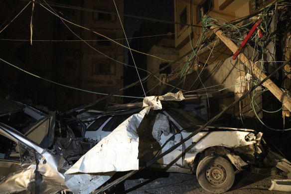Destroyed vehicles and downed power lines on the grounds of Al-Shifa Hospital.